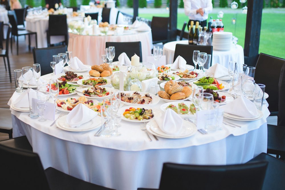 Formal looking round table set with catered meals